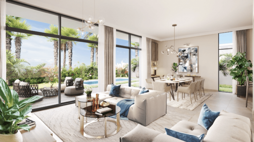 Un salon lumineux et moderne avec de grandes fenêtres, des canapés moelleux, un coin repas à Al Furjan et une vue sur un jardin luxuriant, décoré dans des tons neutres avec des accents bleus et des œuvres d'art contemporaines.