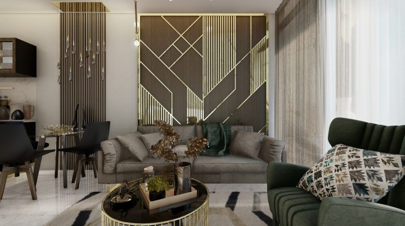 Un salon moderne doté d'un canapé gris adossé à un panneau mural décoratif doré, de chaises vertes moelleuses, d'une table basse circulaire et d'un éclairage subtil dans une propriété de l'immobilier de Dubaï.