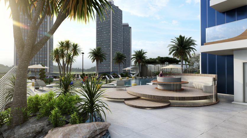Piscine extérieure luxueuse d'un hôtel de grande hauteur à Samana Waves, Dubaï, avec des palmiers, des chaises longues et un coin salon circulaire unique, entouré de tours modernes sous un ciel dégagé