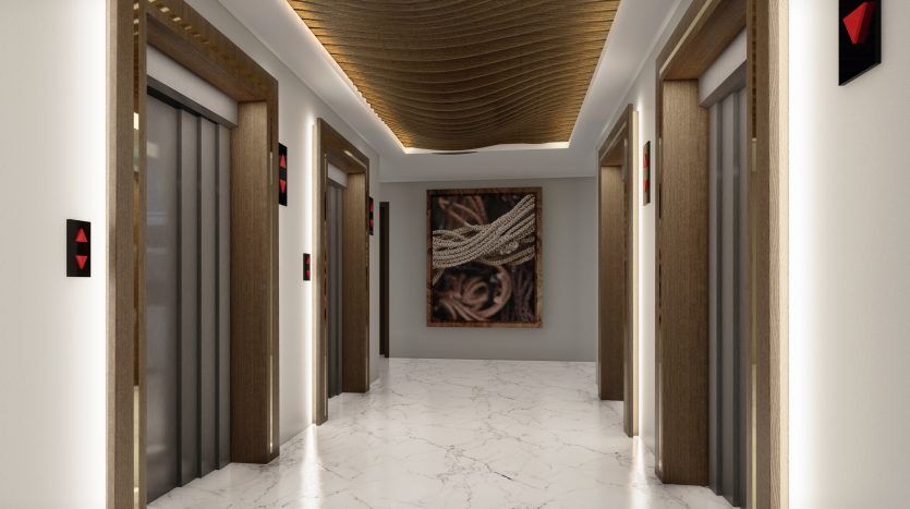 Hall d'ascenseur moderne avec sols en marbre et plafond inspiré de Samana Waves Dubai, avec plusieurs portes d'ascenseur fermées et des œuvres d'art décoratives sur les murs.
