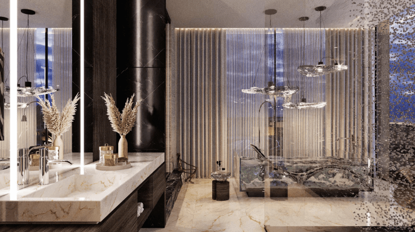 Une salle de bains luxueuse dans un appartement de Dubaï avec des comptoirs en marbre, des lavabos jumeaux et une douche aux parois de verre ornée de luminaires suspendus, à côté d'un coin salon avec un aquarium moderne.