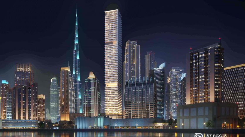 Dubai's illuminated horizon at night, with a river, high-rise buildings of varied architectural design and clear reflections on the water.