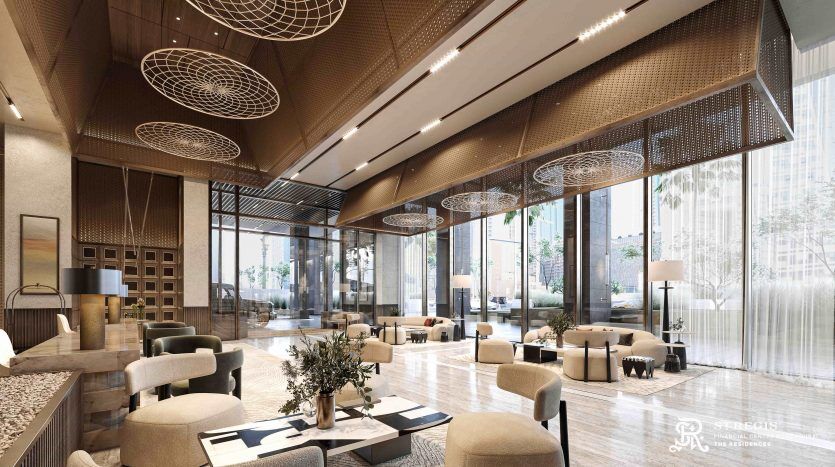A luxurious lobby in Dubai with high ceilings, elegant beige chairs, round decorative hangings, large windows and lush indoor plants.
