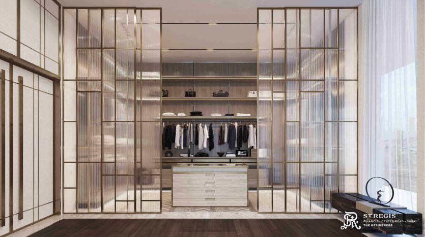 A modern dressing room with a glass partition, neat rows of clothes, a central island with drawers and elegant parquet flooring, bathed in warm ambient lighting, ideal for an investment property.
