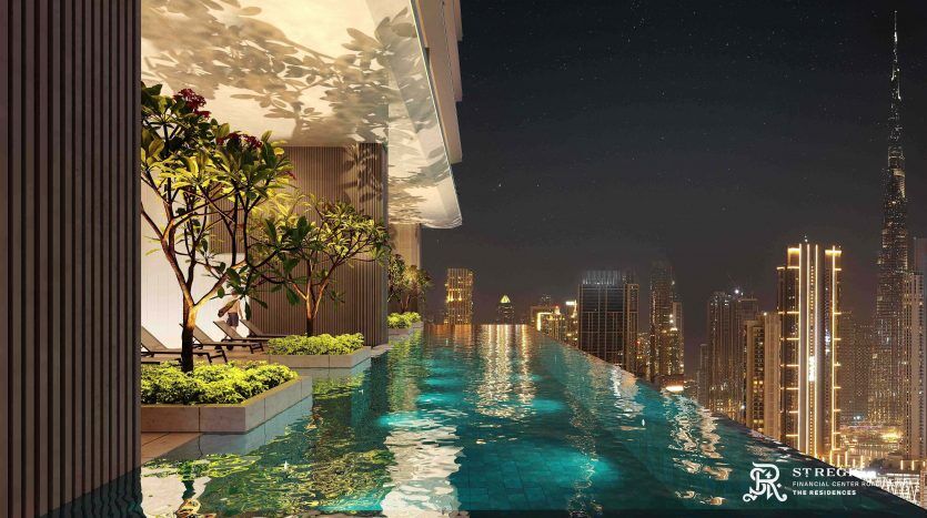 A high-end rooftop pool at night with a sparkling Dubai skyline in the background. The terrace features lush greenery and mood lighting, enhancing the luxurious ambience.