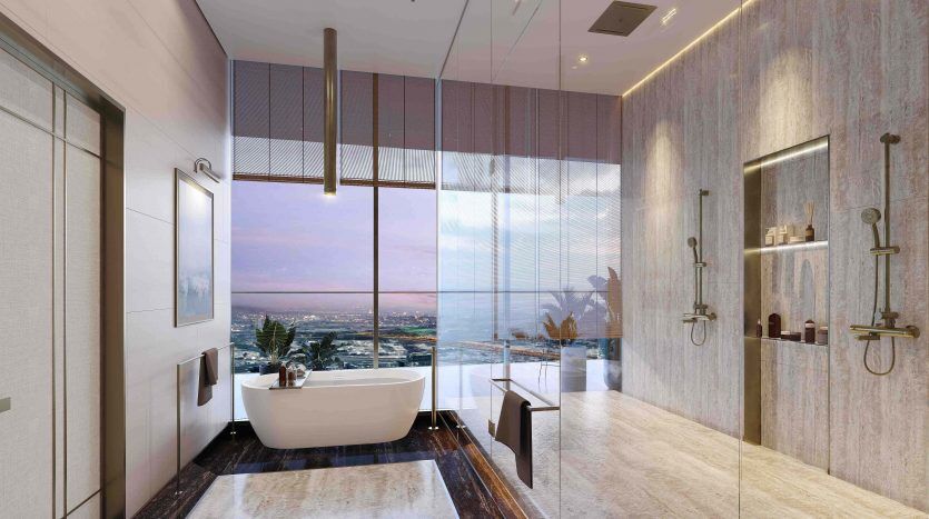 Modern luxury bathroom in a Dubai villa with a freestanding bathtub next to a large window offering panoramic views of the cityscape at sunset, complemented by elegant pendant lights and stylish decoration.