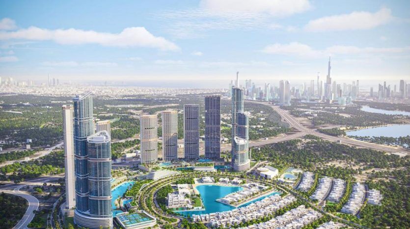 Aerial view of a modern cityscape with towering skyscrapers, a large artificial lake, lush green spaces and curving roads, with distant skyscrapers under a clear sky in Dubai.