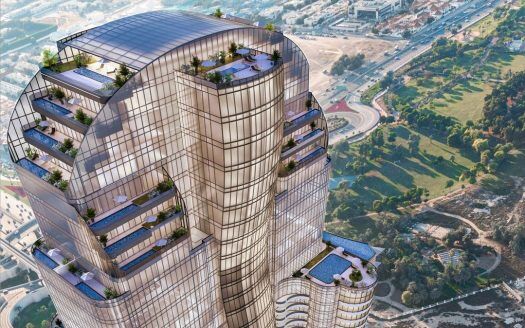 Luftaufnahme eines modernen, mehrstöckigen Wolkenkratzers mit Glasfassaden und mehreren grünen Terrassen in Dubai, umgeben von Stadtlandschaft und Grünflächen.