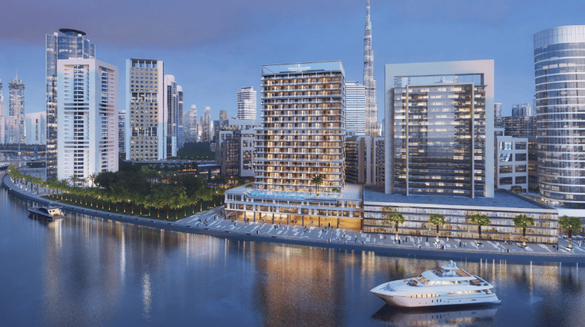 A modern urban skyline at dusk with skyscrapers, illuminated buildings and a yacht on the Dubai River.