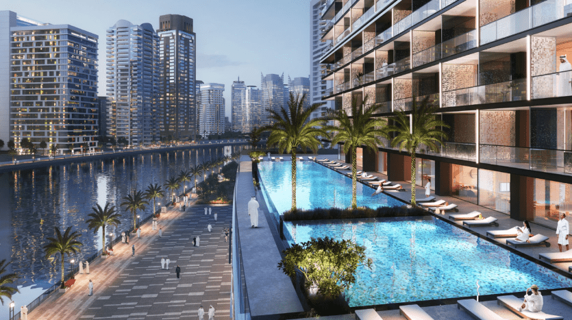 Luxurious urban seafront promenade in Dubai, flanked by modern high-rise buildings, featuring a blue-lit pool, walking paths and scattered sun loungers.