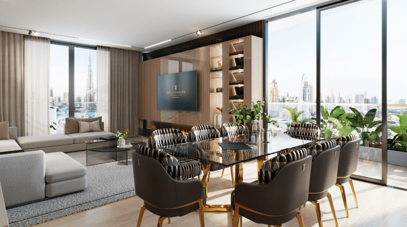 Modern living and dining room in a Dubai apartment with large windows offering city views. The decor includes a plush sofa, a wooden dining table with elegant chairs and indoor plants.