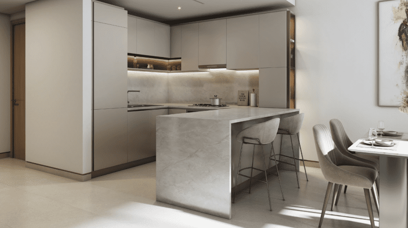 Modern kitchen in a Dubai villa with sleek gray cabinets, a large marble island with bar stools and integrated appliances. Soft lighting and elegant paint enhance the luxurious feel.