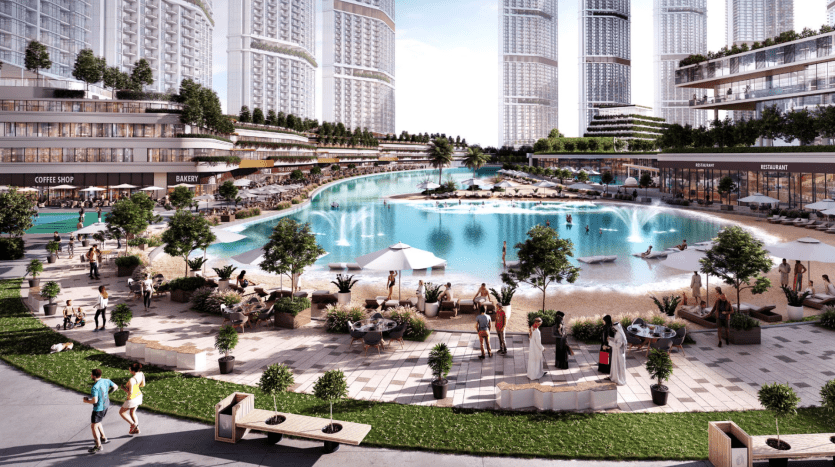 A lively urban beach with a large swimming pool surrounded by skyscrapers. People relax on sun loungers and explore nearby amenities like restaurants and stores, offered by local Dubai real estate agencies.
