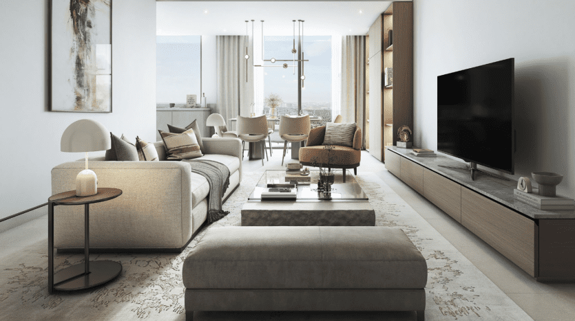 Modern living room in a villa in Dubai with a beige sofa, a matching ottoman and wooden furniture, facing a flat-screen TV. Large windows offer views of the cityscape. A dining area