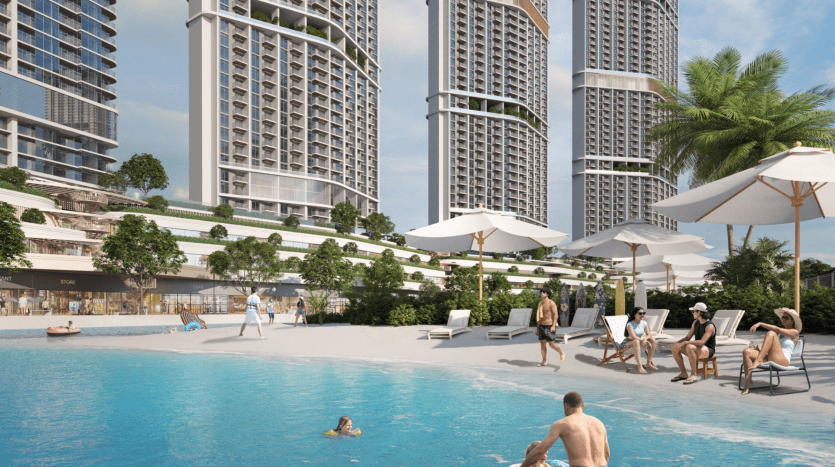 A busy pool scene in a luxury residential complex in Dubai, with several high-rise buildings, people sunbathing and swimming under clear skies and surrounded by lush greenery.