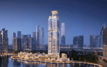 A modern skyscraper with unique twilight-lit balconies, surrounded by other high-rise buildings along a curved waterfront in an urban setting in Dubai.