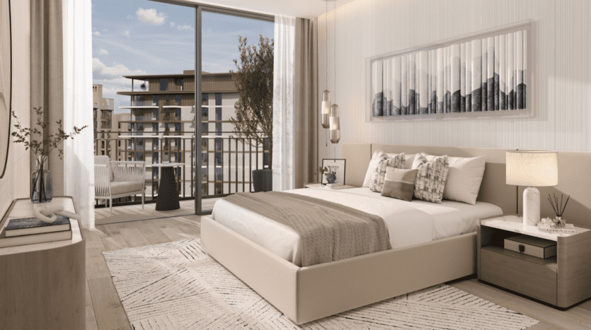 Modern room in a Dubai villa with a king-size bed, white and gray bedding, wooden nightstands, framed artwork and a sliding glass door leading to a balcony with city views.