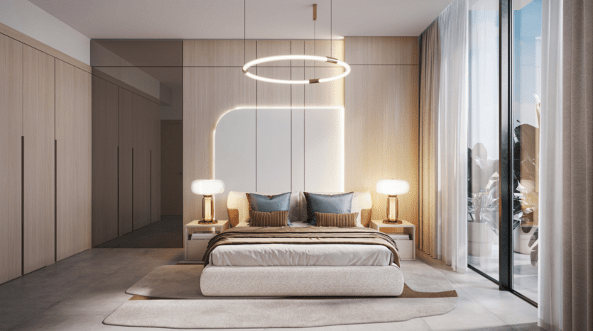 A modern room in beige and white, reminiscent of the Legado Prescott style. It includes a bed with pillows and blanket, two bedside tables with lamps, a large circular ceiling light and picture windows with curtains, allowing natural light to fill the space.