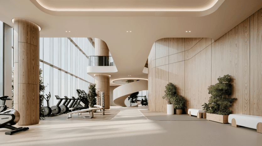 Modern gym with large windows, indoor plants, exercise bikes, treadmills, benches and free weights. Curved wooden walls and a spiral staircase create a bright, open and welcoming atmosphere.