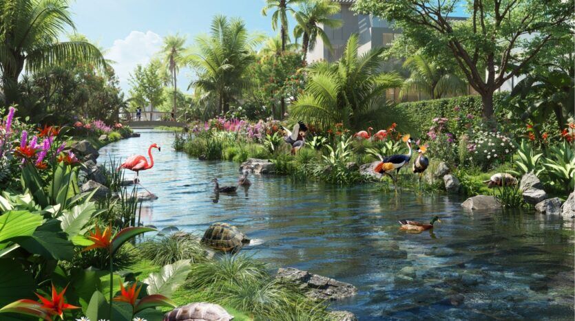 Un jardin tropical luxuriant avec un étang entouré de fleurs éclatantes, de palmiers, de flamants roses, de grues, de tortues et de canards. La lumière du soleil filtre à travers les arbres, avec en arrière-plan une maison et une passerelle qui rappellent la beauté sereine de DAMAC Islands 2.