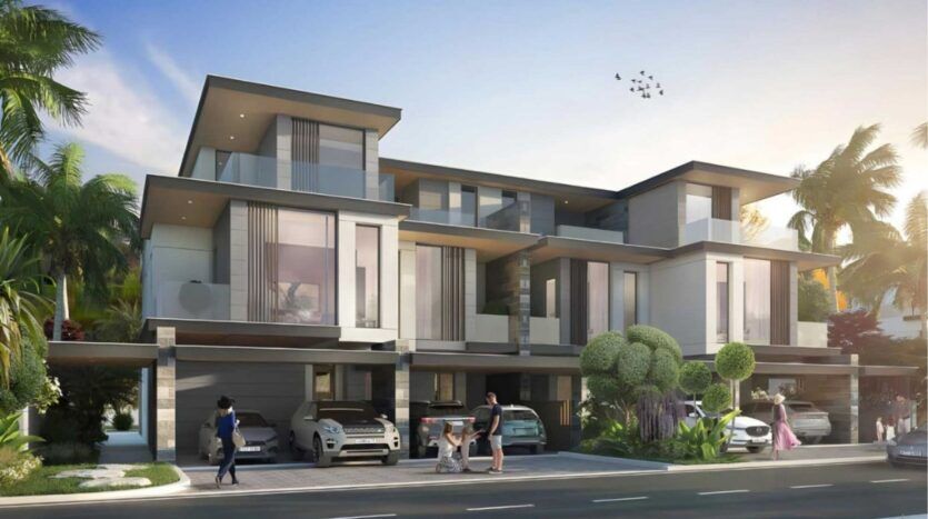 Des maisons modernes de trois étages avec de grandes fenêtres, des balcons et des abris pour voitures définissent Damac Islands 2. Plusieurs personnes, dont des enfants et des adultes, profitent de l'extérieur au milieu des palmiers et de la verdure luxuriante, avec des voitures garées dans les allées.
