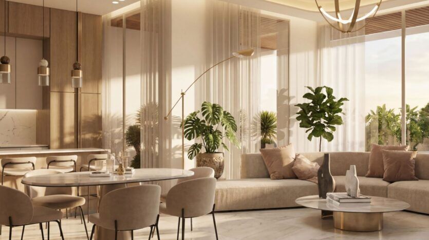 Le salon-salle à manger moderne et baigné de lumière de Lunaya Terraces se caractérise par des tons neutres, des sièges moelleux, une table à manger ronde, des plantes d'intérieur, des rideaux vaporeux et une décoration contemporaine. De grandes baies vitrées laissent la lumière naturelle inonder l'espace.