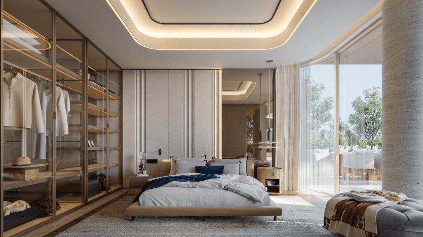 Chambre moderne avec un grand lit, des coussins moelleux et une couverture soigneusement pliée. Les baies vitrées du Vitalia laissent entrer la lumière naturelle. Un dressing spacieux avec étagères et vêtements suspendus se trouve sur la gauche. D'élégants plafonniers rehaussent cette retraite de Palm Jumeirah.