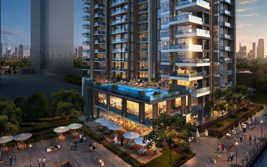 Immeuble d'appartements moderne de grande hauteur doté d'une terrasse spacieuse dotée d'une piscine et de sièges extérieurs, entouré d'une verdure luxuriante au crépuscule, avec les toits de la ville de Dubaï en arrière-plan. Idéal pour ceux qui cherchent à investir