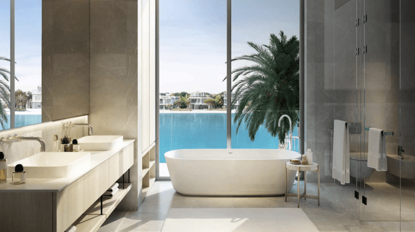 A luxurious bathroom with a freestanding bathtub, two sinks and a shower, overlooking a tranquil outdoor pool surrounded by palm trees in a Dubai apartment. Large picture windows offer a view of a