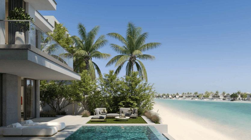 Modern luxury beachfront villa in Dubai with infinity pool, palm trees and tranquil ocean views under a clear blue sky. Outdoor furnishings enhance the serene setting.