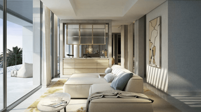 A modern, luxurious living space with elegant cream-colored furniture, bay windows and a view overlooking a sunny patio in a distinguished Dubai villa. Natural light fills the room, highlighting the
