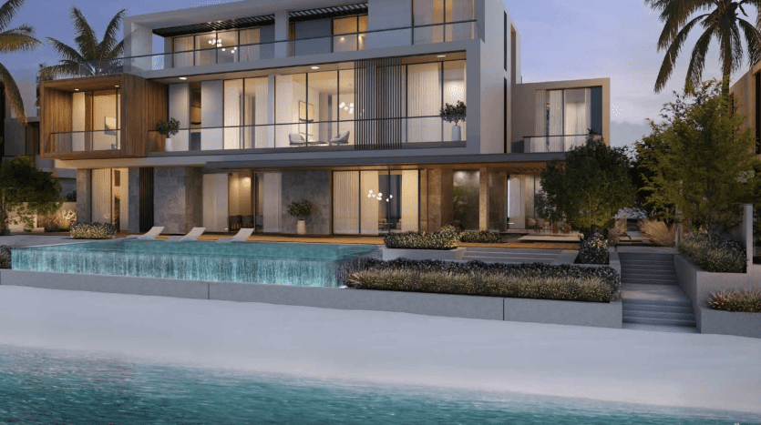 Modern two-storey beach apartment in Dubai with large glass windows, balconies and evening-lit pool surrounded by landscaped gardens.
