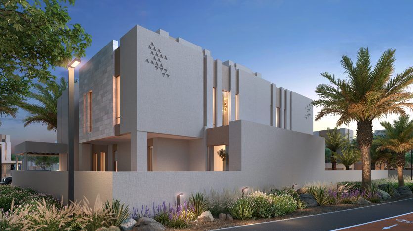 Bâtiment moderne de deux étages avec des détails de façade géométriques au crépuscule, entouré de palmiers et d'un aménagement paysager luxuriant sous un ciel teinté de rose, parfait pour une vitrine d'appartement à Dubaï.