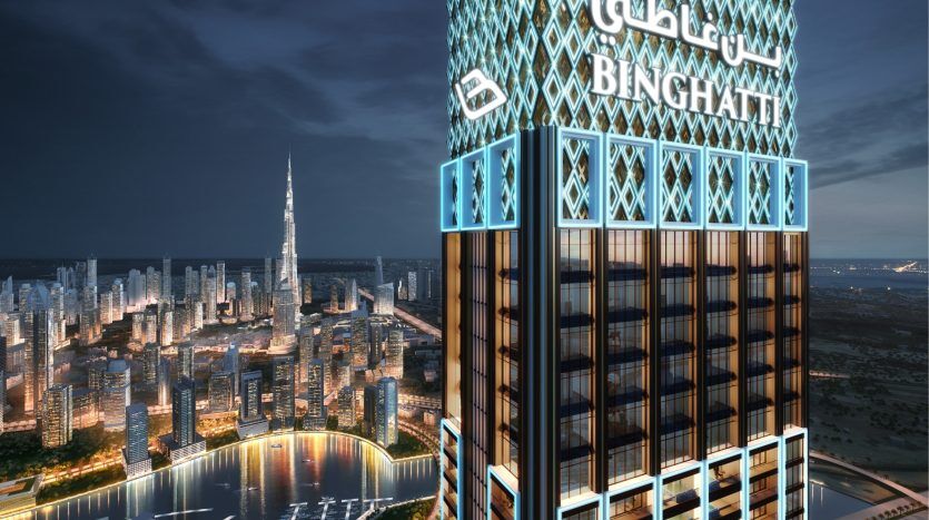 A digital rendering of a modern skyscraper at night, lit by blue lights, prominently displaying the "Binghatti" brand, against a backdrop of city rooftops featuring Dubai real estate and its tall buildings.
