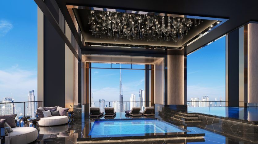 Luxurious, elegantly designed indoor pool with reflective surfaces, modern loungers and a spectacular chandelier, overlooking the Dubai skyline through large windows.