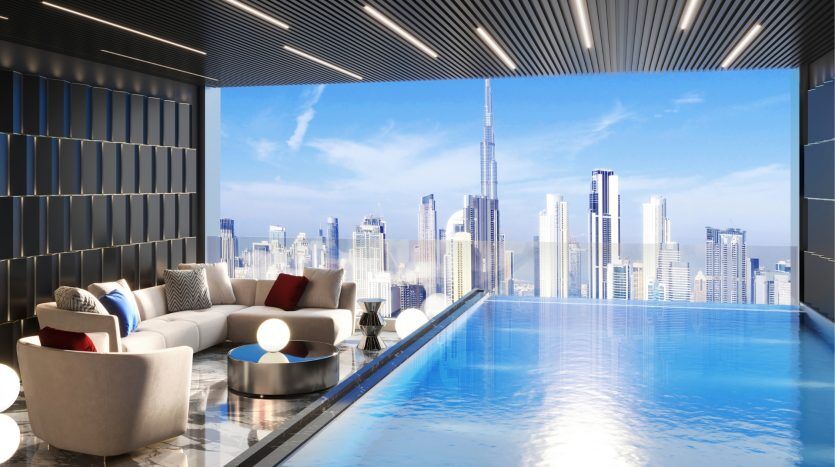 Luxurious rooftop infinity pool overlooking a modern cityscape with skyscrapers in Dubai, with comfortable seating areas under a shaded terrace.