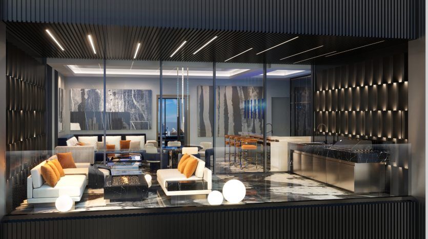Spacious, modern living room with integrated kitchen featuring elegant, contemporary furnishings, stylish pendant lighting and panoramic ocean views through bay windows in a high-end apartment in Dubai.