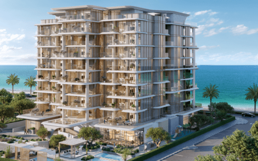 Un immeuble moderne de plusieurs étages avec balcons surplombant l'océan, rappelant les structures luxueuses de Vitalia Palm Jumeirah. Des palmiers bordent la rue et le ciel est dégagé avec quelques nuages. Le cadre est serein, avec une végétation luxuriante enveloppant la structure.
