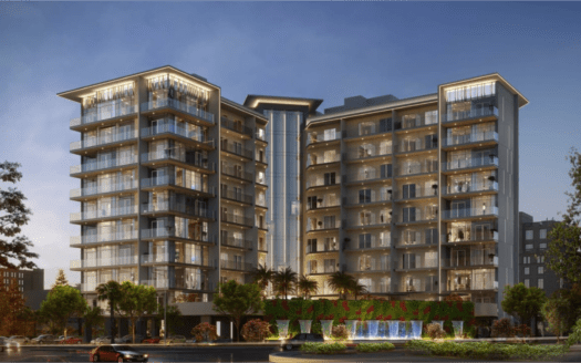 Au crépuscule, l'immeuble d'appartements Floarea Grande se présente moderne et illuminé. La structure dispose de nombreux balcons et de grandes fenêtres, avec une entrée paysagée avec des palmiers et une fontaine à eau au rez-de-chaussée.