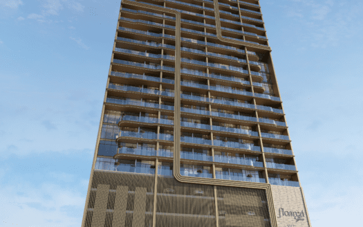 Un immeuble moderne de grande hauteur avec des balcons en verre et des lignes verticales et horizontales distinctives s'élève dans le ciel de la zone florale, vu sous un angle bas contre un ciel bleu avec des nuages épars.