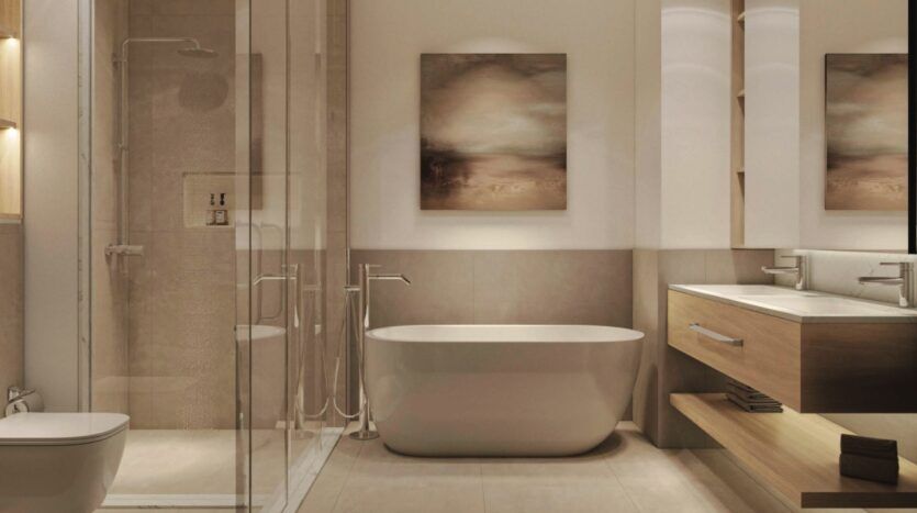 Salle de bains moderne à Vida Residences Saadiyat Island avec une baignoire autoportante, une douche vitrée, un meuble-lavabo flottant en bois avec deux lavabos, un grand miroir et des œuvres d'art abstraites. Le design est minimaliste avec des tons neutres.