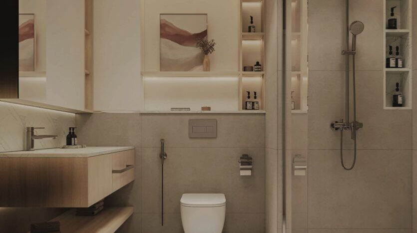 Salle de bains moderne à Vida Residences Saadiyat Island avec carrelage beige, toilettes murales, meuble-lavabo flottant en bois, douche en verre, étagères encastrées pour les articles de toilette, éclairage d'ambiance doux et art abstrait encadré au-dessus des toilettes.