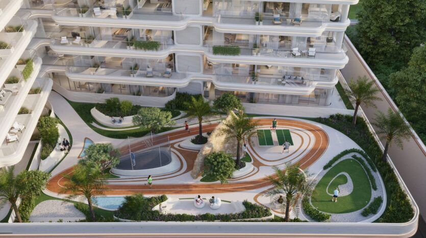 Vue aérienne de la cour du complexe d'appartements Weston by Wadan, avec une piste de course, un aménagement paysager, des bancs, une aire de jeux, un terrain de basket-ball et des personnes profitant des aménagements extérieurs.