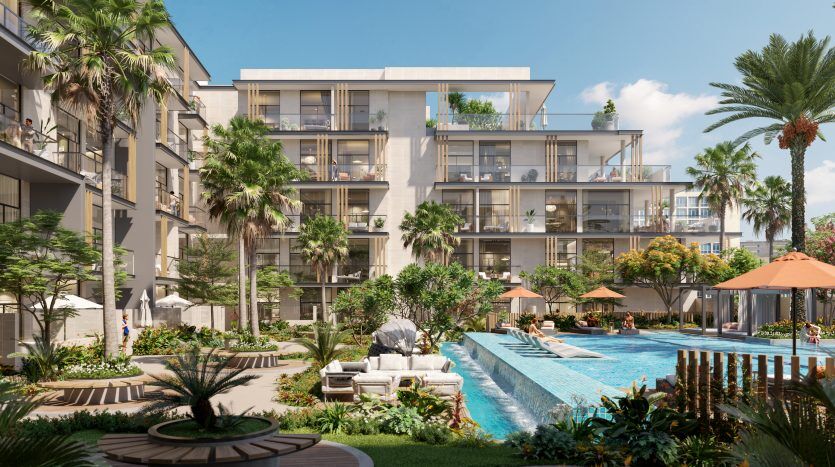 Un complexe d'appartements luxueux avec une grande piscine entourée de palmiers, de chaises longues et de plusieurs bâtiments modernes sous un ciel bleu clair à Oxford 212.