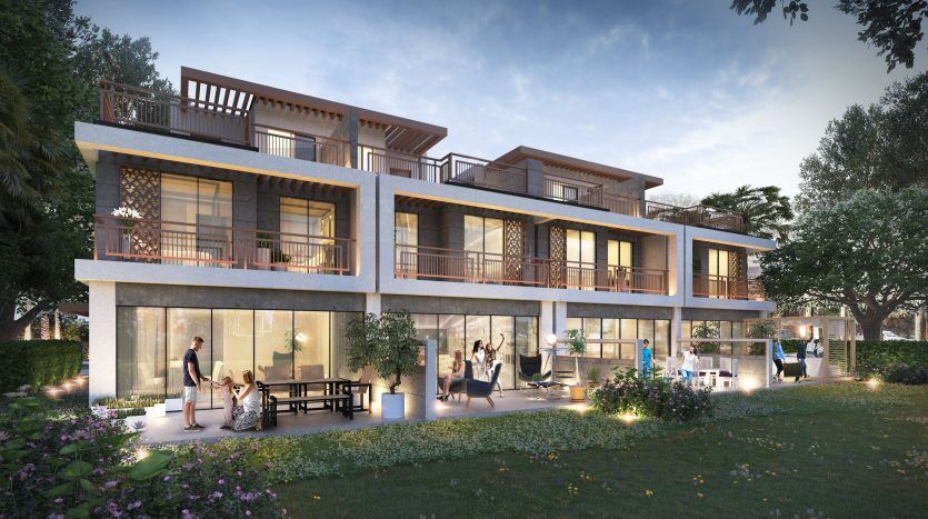 Immeuble résidentiel moderne de plusieurs étages à Dubaï au crépuscule avec des intérieurs bien éclairés, avec des personnes participant à diverses activités et une verdure luxuriante autour.