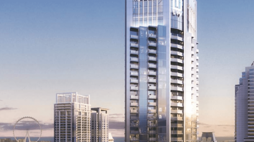 Un gratte-ciel moderne se dresse bien en évidence sur un ciel de coucher de soleil à Dubaï, entouré d'autres immeubles de grande hauteur avec un aperçu d'une grande roue en arrière-plan.