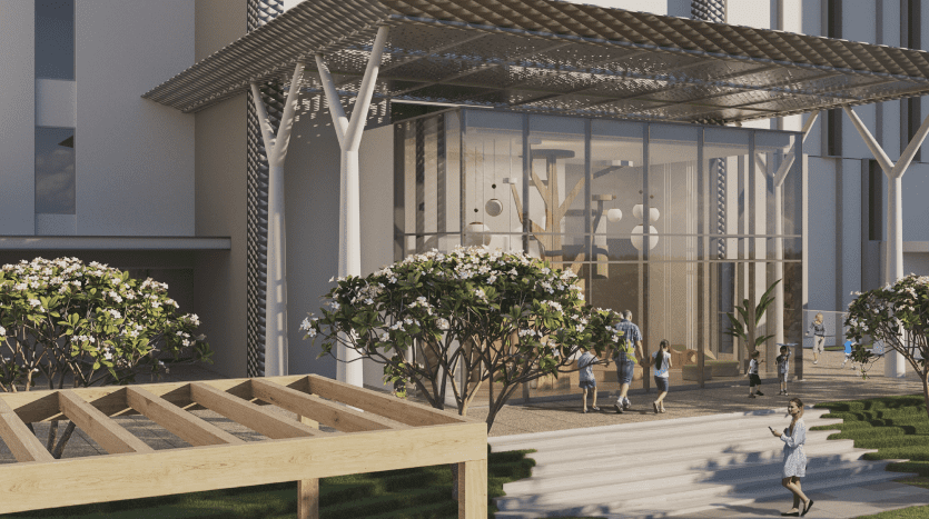 Entrée d'un bâtiment moderne à Dubaï avec une façade en verre et un auvent géométrique. Les gens marchent et interagissent dans un espace paysager avec des bancs et des arbres.