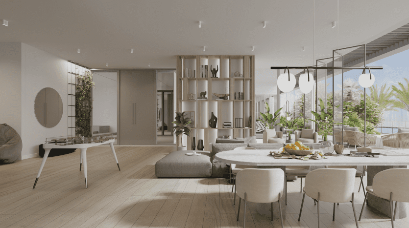 Salon moderne et spacieux avec coin repas doté d'une grande table en bois, de chaises contemporaines et d'une bibliothèque élégante. De grandes fenêtres laissent entrer la lumière naturelle et offrent une vue sur les palmiers à l'extérieur de la villa.