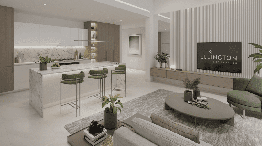 Cuisine et salon modernes comprenant un îlot en marbre, des armoires blanches, un canapé vert et un mur texturé étiqueté "Ellington Properties - Immobilier Dubai.