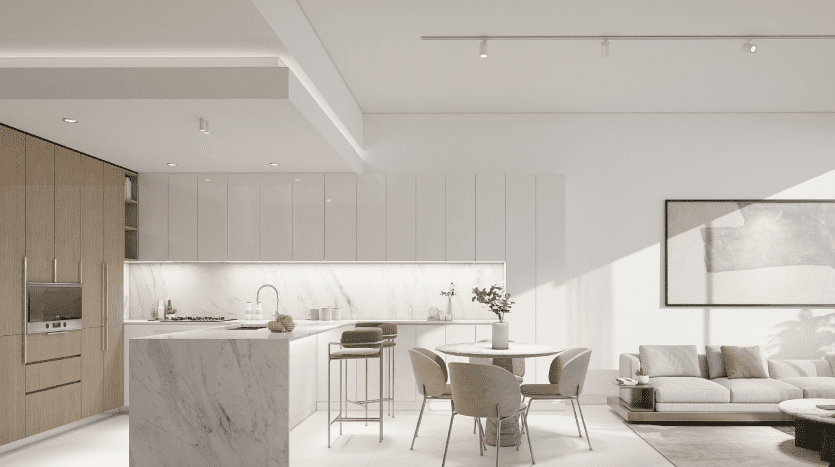 Une cuisine et un salon modernes et minimalistes avec des armoires blanches élégantes, un îlot en marbre, des accents en bois clair et un mobilier contemporain sous la lumière naturelle dans un appartement haut de gamme à Dubaï.